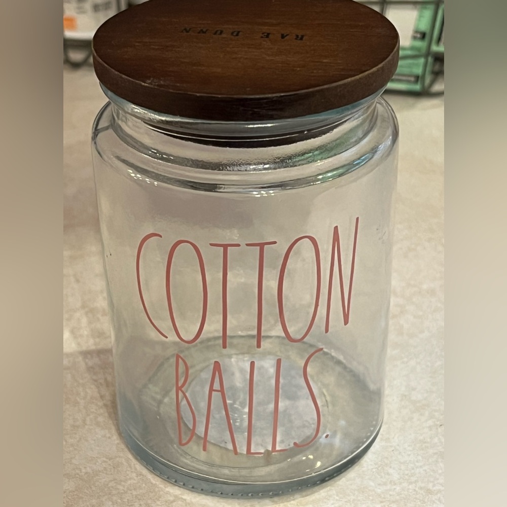 Rae Dunn glass with wood lid container with red lettering “COTTON BALLS”